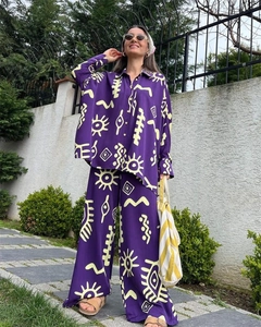 Detail of purple long-sleeved shirt and wide-leg pants with bohemian geometric prints