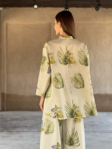 Detail of tropical print cotton linen set featuring wide-leg pants and loose long sleeves