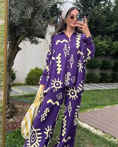 Detail of purple floral two-piece set with yellow abstract prints and wide-leg trousers