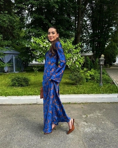 Detail of dark blue floral maxi dress with orange flowers and flowy long sleeves
