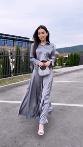 Detail of elegant gray satin long sleeve shirt and matching high waist maxi skirt set