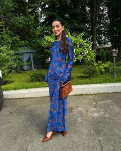 Close-up of long sleeve floral maxi dress in blue and brown with waist tie detail