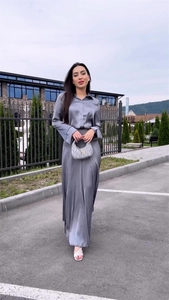 Detail of elegant silver grey satin long sleeve shirt and high waist midi skirt set