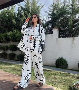 Detail of two-piece set with fashion abstract eye print long sleeve shirt and wide leg pants