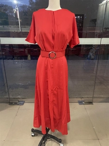 Detailed view of long red short-sleeve dress featuring a waist belt with silver metal buckle