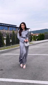 Detail of silver grey satin two-piece set featuring long-sleeve shirt and high-waist maxi skirt