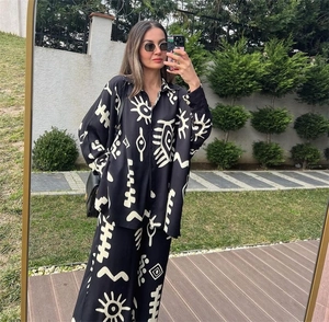 Detail of floral printed loose shirt and high waist wide leg pants set outdoors