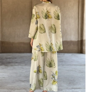 Back view of women's linen-blend set with tropical monstera and palm leaf print