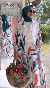 Detailed view of floral print long cardigan and wide leg pants in a vacation style