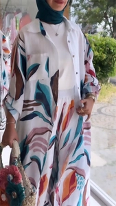 Detail of vibrant leaf print on two-piece loose vacation set with shirt and wide-leg trousers