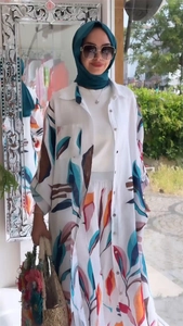 Detail of printed long cardigan and wide leg pants set with colorful leaf patterns