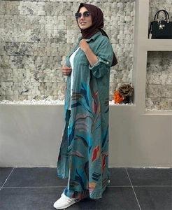 Detail of teal linen-textured long cardigan with abstract leaf print and buttoned cuffs