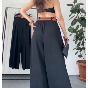 Women high waist wide leg trousers in black fabric with a brown faux leather belt