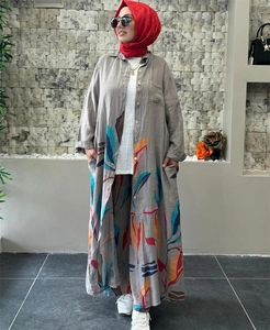 Detailed texture of cotton linen fabric with colorful tropical leaf prints on a gray suit