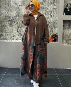 Detailed view of bohemian style brown cotton-linen shirt with tropical leaf pattern print
