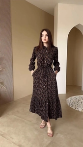 Detail of elegant long sleeve brown dress with letter print and waist tie design