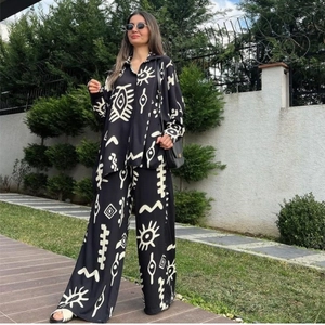 Women's 2-piece set with abstract print shirt and high-waist wide-leg pants on outdoor lawn