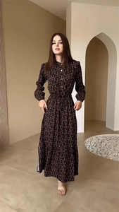 Close-up of elegant coffee brown long dress with gold letter print and belted waist detail