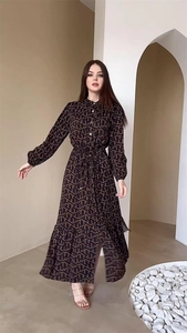 Detail of elegant brown patterned maxi dress with waist tie and button-front design