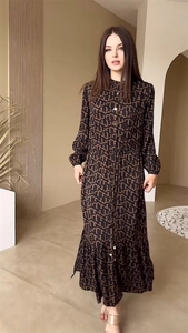 Detail of elegant brown monogram maxi dress with waist tie and button-down design
