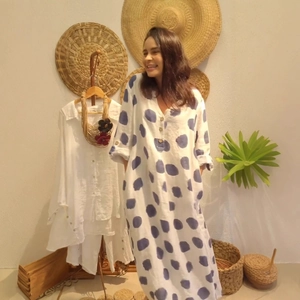 Detailed view of women's V-neck polka dot maxi dress made of breathable cotton linen fabric