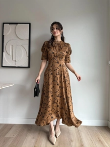 Detail of satin floral maxi dress with puff sleeves and cinched waist for women