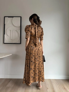 Detail of elegant satin dress showing rear neck tie and vintage floral print