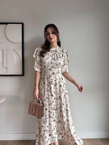 Detailed view of puff sleeves and floral satin fabric on an elegant midi dress