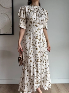 Detail of elegant satin maxi dress with vintage olive botanical print and puff sleeves