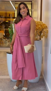 Detail of elegant pink sleeveless shirt dress featuring a lapel collar and wide waist belt