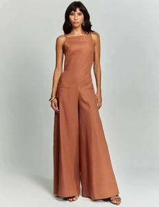 Detail of caramel brown wide-leg jumpsuit with thin straps and textured linen fabric
