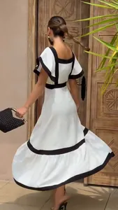 Detail of square neckline and black contrast trim on elegant white midi dress