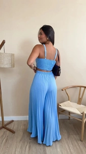 Detail view of light blue two-piece set featuring pleated wide-leg pants and adjustable camisole