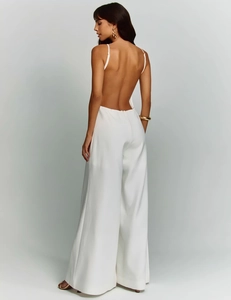 Elegant white backless wide-leg jumpsuit with thin straps and draped fabric detail