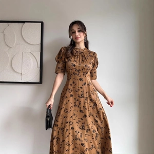 Elegant satin floral maxi dress in golden brown with puff sleeves and cinched waistline