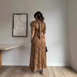 Elegant brown satin maxi dress with leaf print and open back tie detail for women