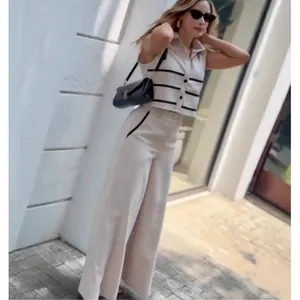 Detail of sleeveless striped top and high-waist trousers set in elegant minimalist style