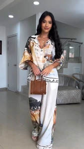 Detail of artistic architectural print two-piece set with flowy shirt and wide-leg trousers
