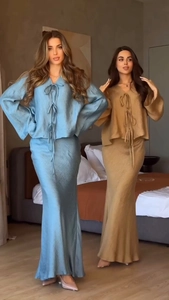 Detailed texture of elegant satin long sleeve tie-up top and long skirt set for women