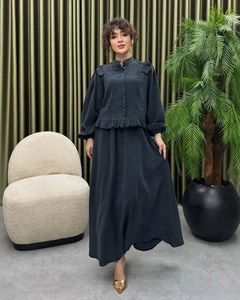 Detail view of the charcoal grey two-piece set featuring ruffled stand collar and elegant long skirt