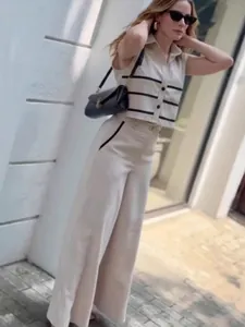 Women's chic beige sleeveless cropped top and wide-leg trousers set with black stripes