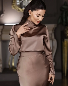 Detail of elegant brown satin top with high collar and luxurious silk texture