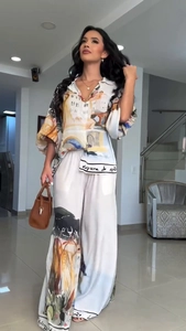 Detail of loose-fit shirt and wide-leg trousers set with artistic scenic print