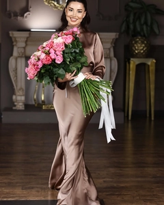 Close-up of elegant brown satin dress texture and premium fabric drape on model