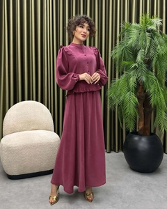 Detailed close-up of high-neck dark plum dress with elegant ruffles and lantern sleeves