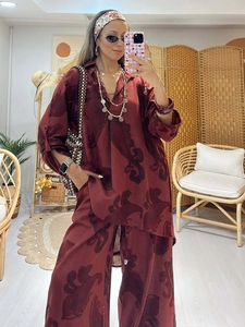Close-up of bohemian floral print fabric on loose fit shirt and wide leg pants set
