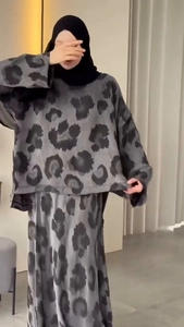 Detail of modest two-piece set featuring long sleeve top and skirt with leopard print