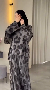 Detail view of the gray leopard print pattern on long sleeve top and wide leg pants
