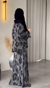 Detail of grey leopard print long sleeve top and maxi skirt set with draped fabric texture