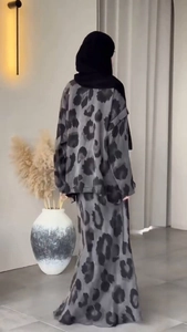 Detail view of the back of a modest two-piece set with elegant gray ink leopard print